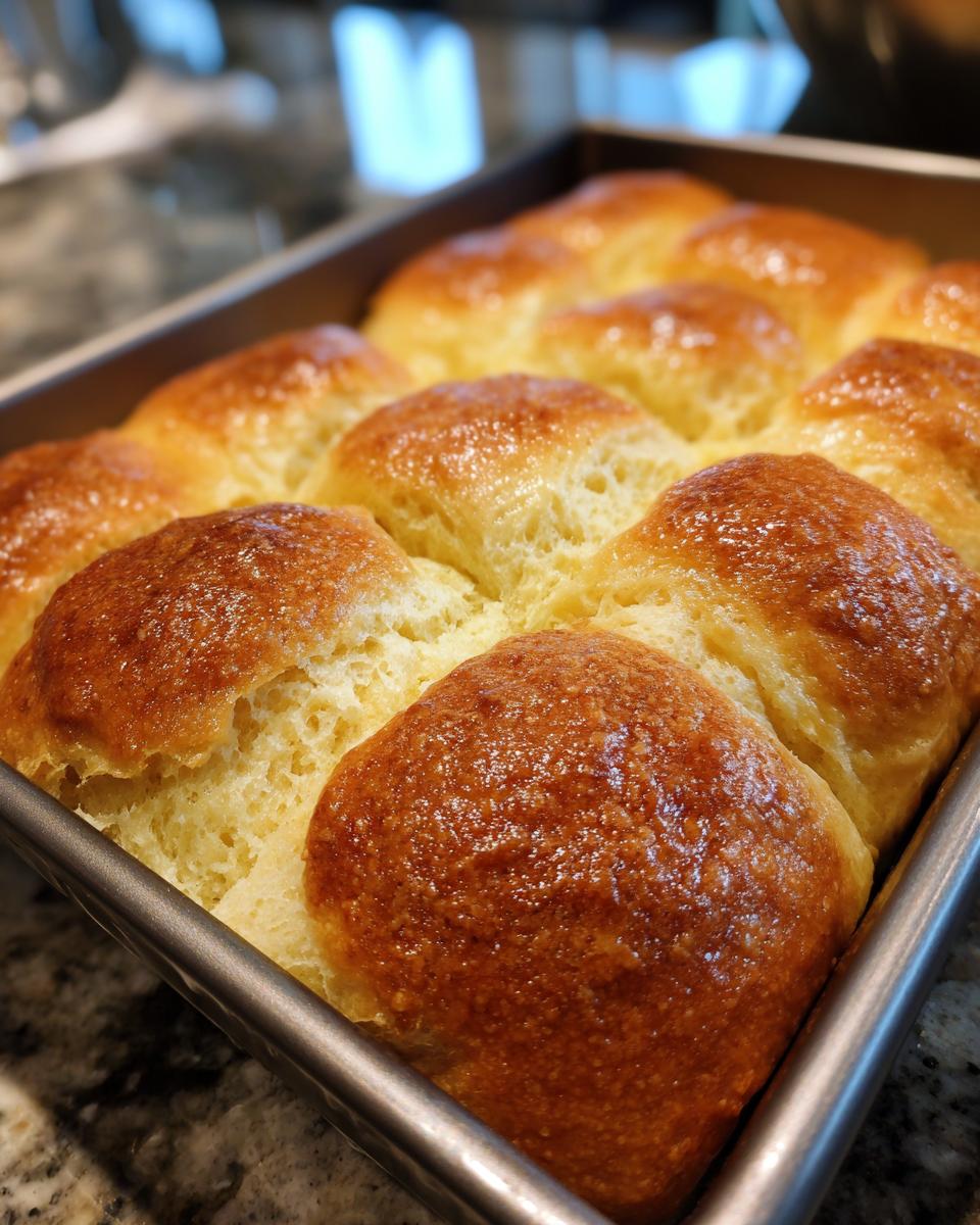 Golden brown, freshly baked beef and bowtie pasta rolls in a baking pan.