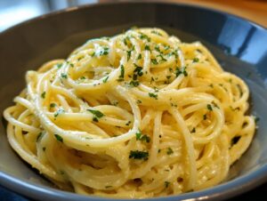 A close-up of a bowl of delicious Creamy Lemon Pasta, tossed with fresh parsley.
