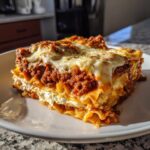A hearty slice of Lasagna with Cottage Cheese, showing layers of pasta, rich meat sauce, and creamy cottage cheese filling.