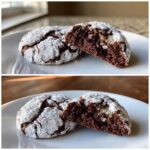 Two fudgy chocolate crinkle cookies on a white plate, one broken in half showing the moist interior.