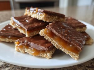 A stack of rich Caramel Ritz Cracker Christmas Cookies featuring a crunchy base, thick caramel layer, and chocolate topping.