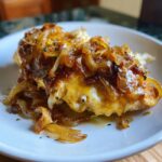 Close-up of baked french onion chicken topped with melted cheese and caramelized onions.