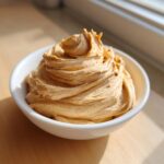 A swirl of rich, spiced cinnamon butter is presented beautifully in a small white bowl.